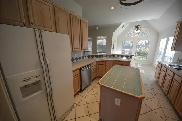 a kitchen with sink a refrigerator and cabinets