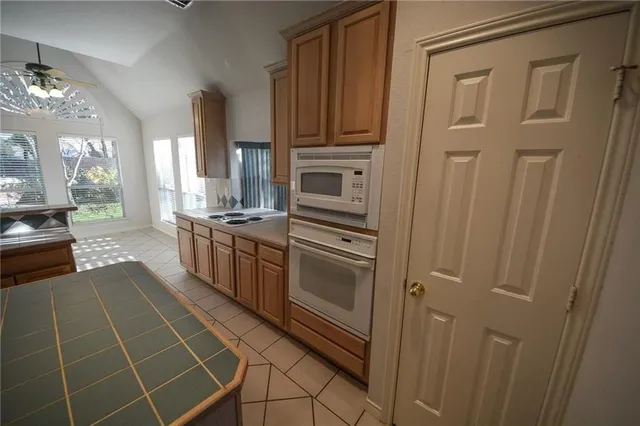 a kitchen with stainless steel appliances a stove a sink and a refrigerator