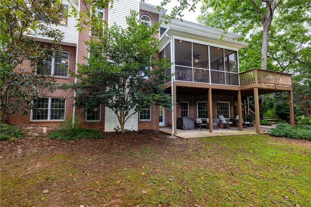 106 Red Maple Way Clemson, SC 29631 - Photo 38 of 49 Multi-level outdoor living areas blend brick craftsmanship with elevated deck spaces.