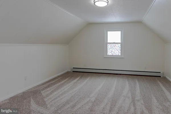 a view of a room with wooden floor and window