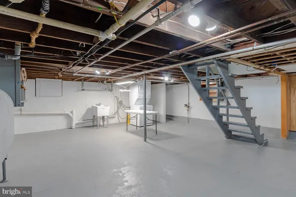 a view of water heater room with stairs
