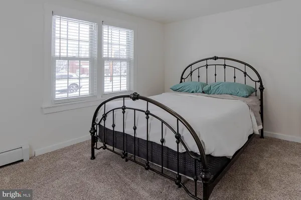 a bed sitting in a bedroom next to a window