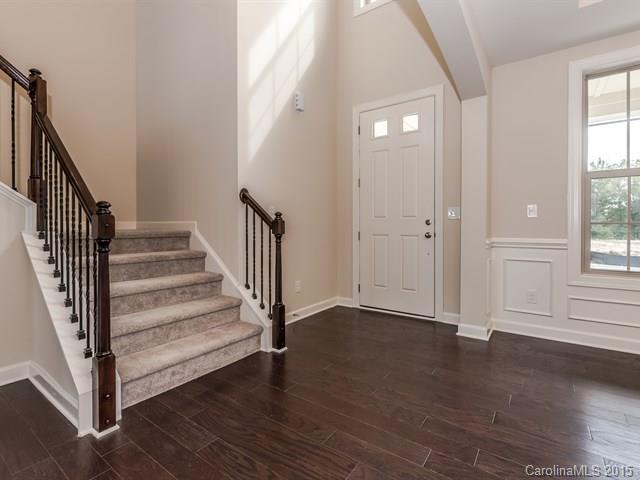 1404 Cilantro Court, Unit 309 Tega Cay, SC 29708 - Photo 3 of 24 a view of a hallway with wooden floor and front door
