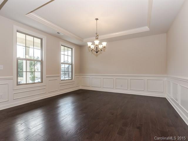 1404 Cilantro Court, Unit 309 Tega Cay, SC 29708 - Photo 4 of 24 an empty room with wooden floor and windows