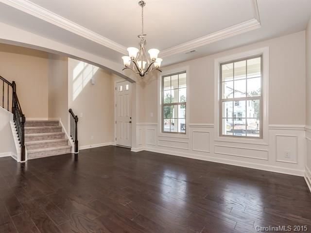 1404 Cilantro Court, Unit 309 Tega Cay, SC 29708 - Photo 5 of 24 a view of an empty room with wooden floor and a window