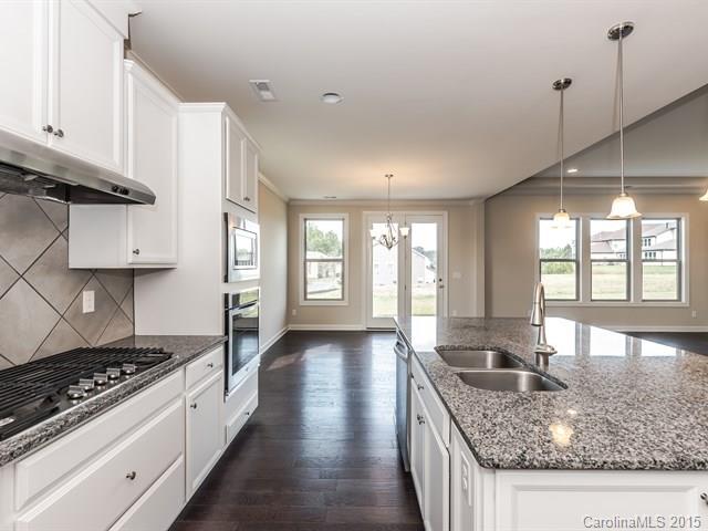 1404 Cilantro Court, Unit 309 Tega Cay, SC 29708 - Photo 7 of 24 a kitchen with stainless steel appliances granite countertop a stove a sink and a refrigerator