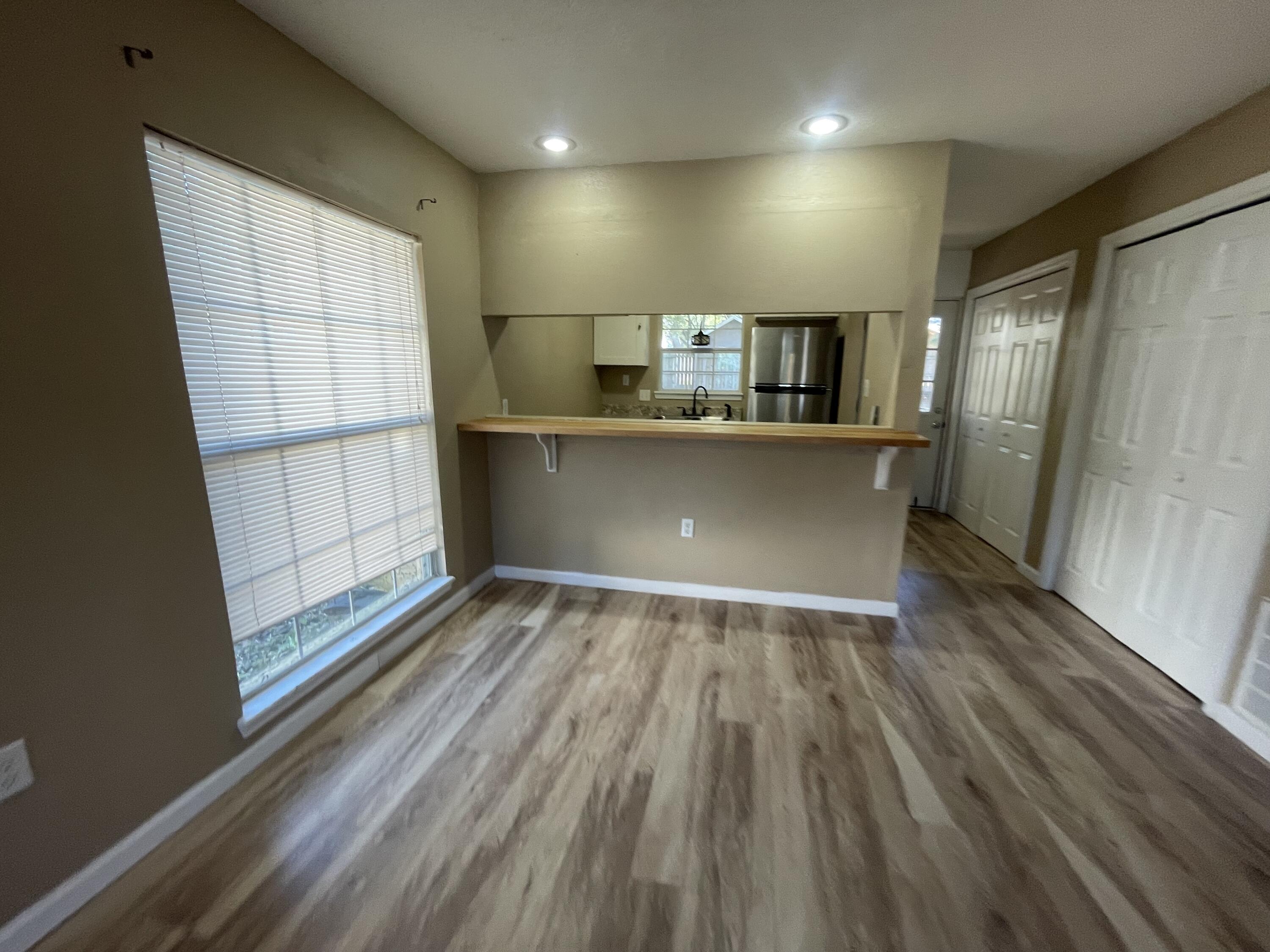 607 West Sunset Boulevard, Unit A Fort Walton Beach, FL 32547 - Photo 3 of 13 a view of kitchen with furniture and wooden floor