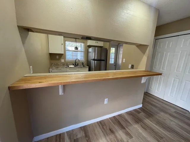 a view of water heater room with wooden floor