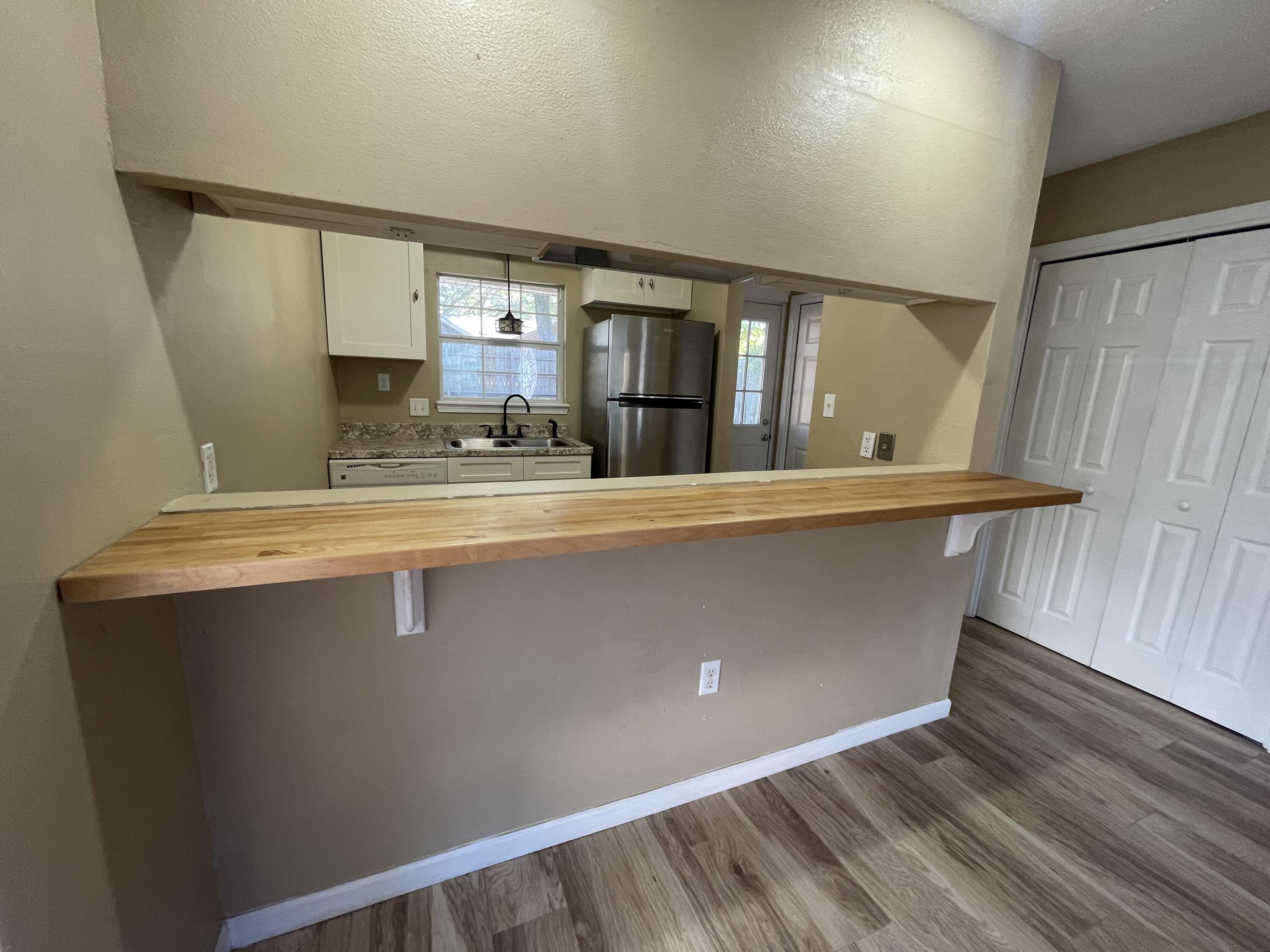 607 West Sunset Boulevard, Unit A Fort Walton Beach, FL 32547 - Photo 4 of 13 a view of water heater room with wooden floor