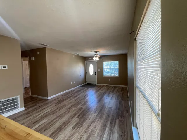 wooden floor in an empty room with a window