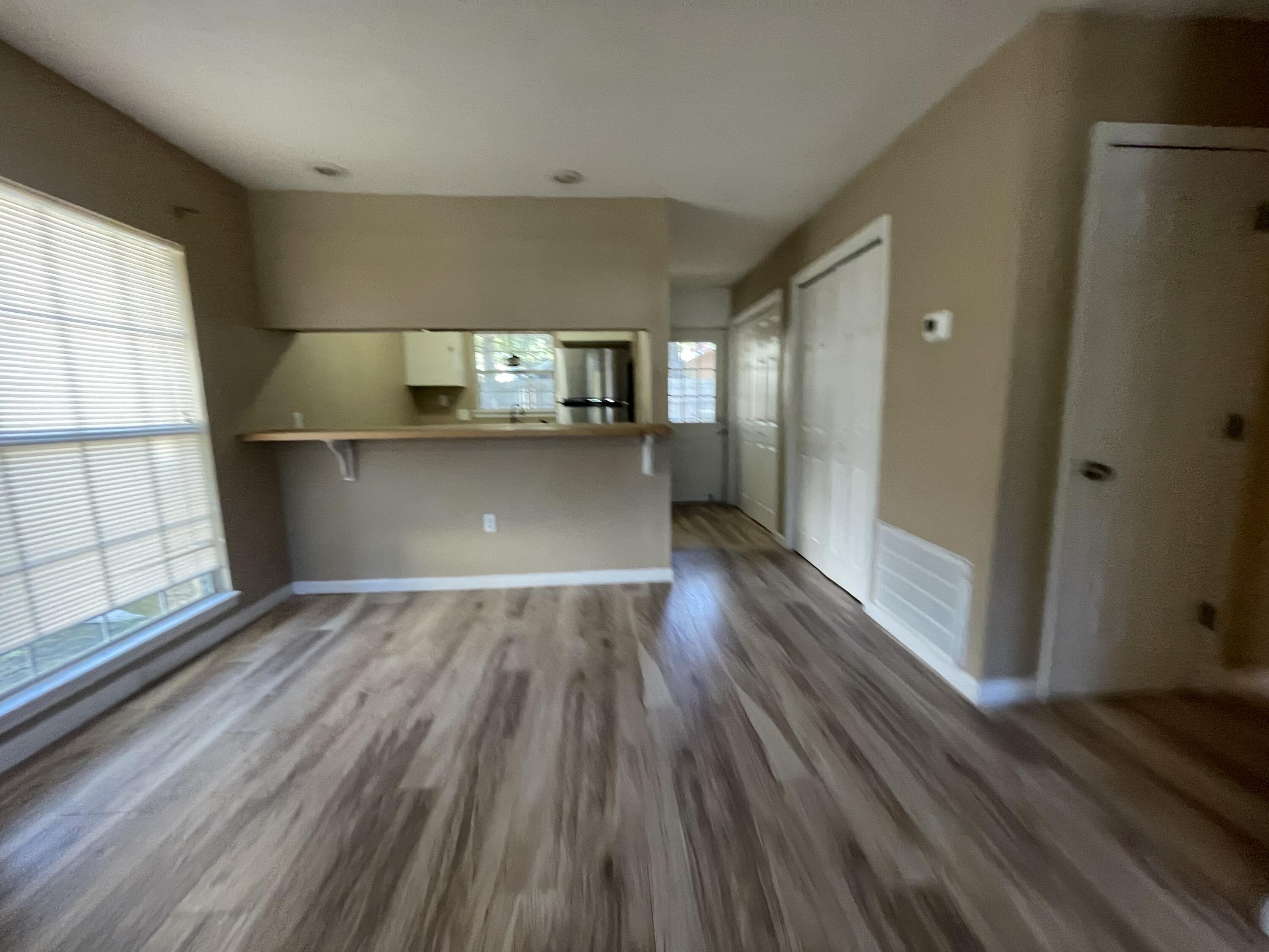 607 West Sunset Boulevard, Unit A Fort Walton Beach, FL 32547 - Photo 8 of 13 a view of kitchen and empty room with wooden floor