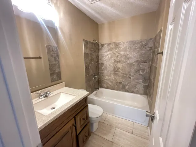 a bathroom with a sink a toilet and a bathtub