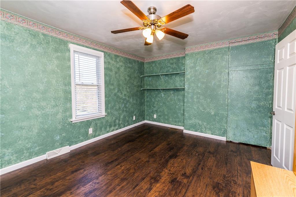 243 Marshall Road Oakdale, PA 15071 - Photo 13 of 24 The first of two, large bedrooms situated on the main floor with new laminate flooring, new doors with new hardware and new white baseboards and window-trim. Ceiling fan with light.