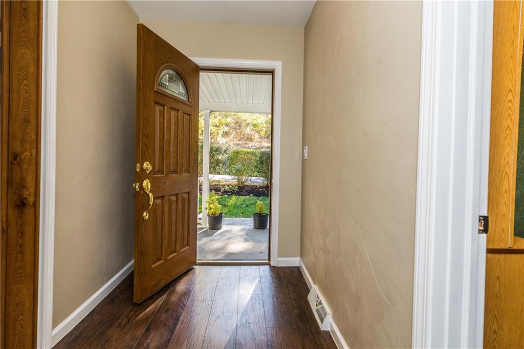 243 Marshall Road Oakdale, PA 15071 - Photo 3 of 24 Entry hallway with new laminate flooring, new door and hardware. Neutral color paint, white trim and baseboards. (Check out the beautifully-covered front porch, perfect for enjoying a relaxing evening!)