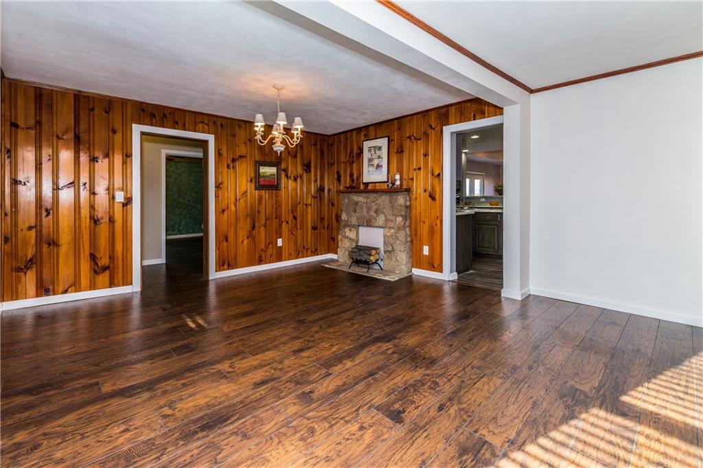 243 Marshall Road Oakdale, PA 15071 - Photo 4 of 24 Enjoy this gorgeous, updated living and dining rooms (if you so choose...) with new laminate flooring, new white trim, crown molding and freshly painted walls. The knotty pine paneling is cozy and inviting. (Stone fireplace is decorative only.)