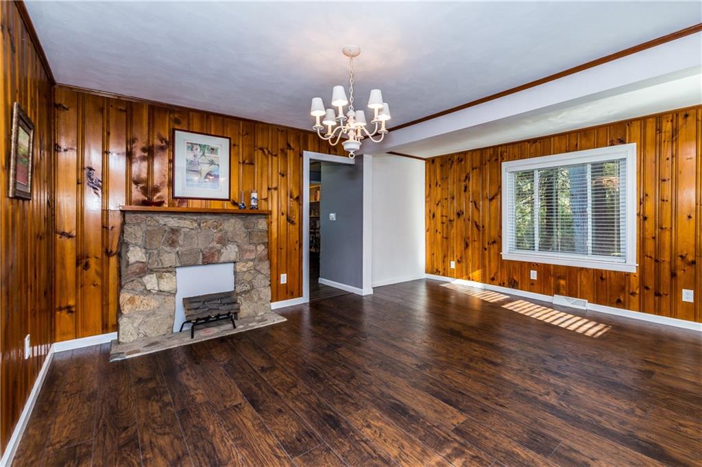243 Marshall Road Oakdale, PA 15071 - Photo 5 of 24 The living and dining rooms (if you so choose...) with new laminate flooring, new white trim, freshly painted walls, crown molding, and cozy knotty pine paneling. Windows reveal beautiful acreage.