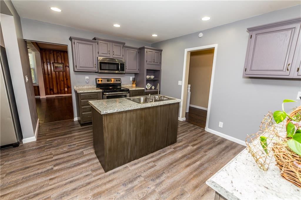 243 Marshall Road Oakdale, PA 15071 - Photo 6 of 24 Gourmet, updated, remodeled, eat-in kitchen with stainless appliances, refinished cabinets, new laminate flooring, new sink and faucet, vast island, huge pantry (to the left of the photo), and recessed lighting. Perfect for everyday living or entertaining a crowd!