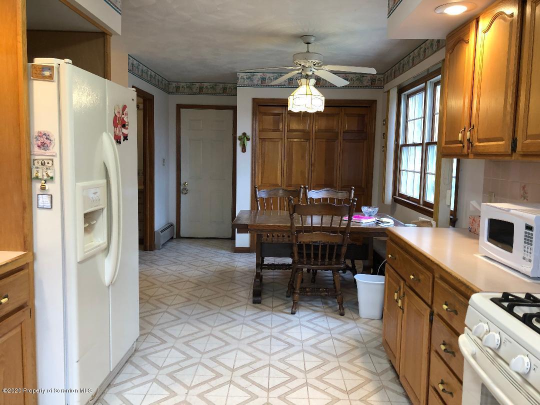 14 Ridgeview Drive Scranton, PA 18504 - Photo 5 of 23 a kitchen with refrigerator cabinets dining table and chairs