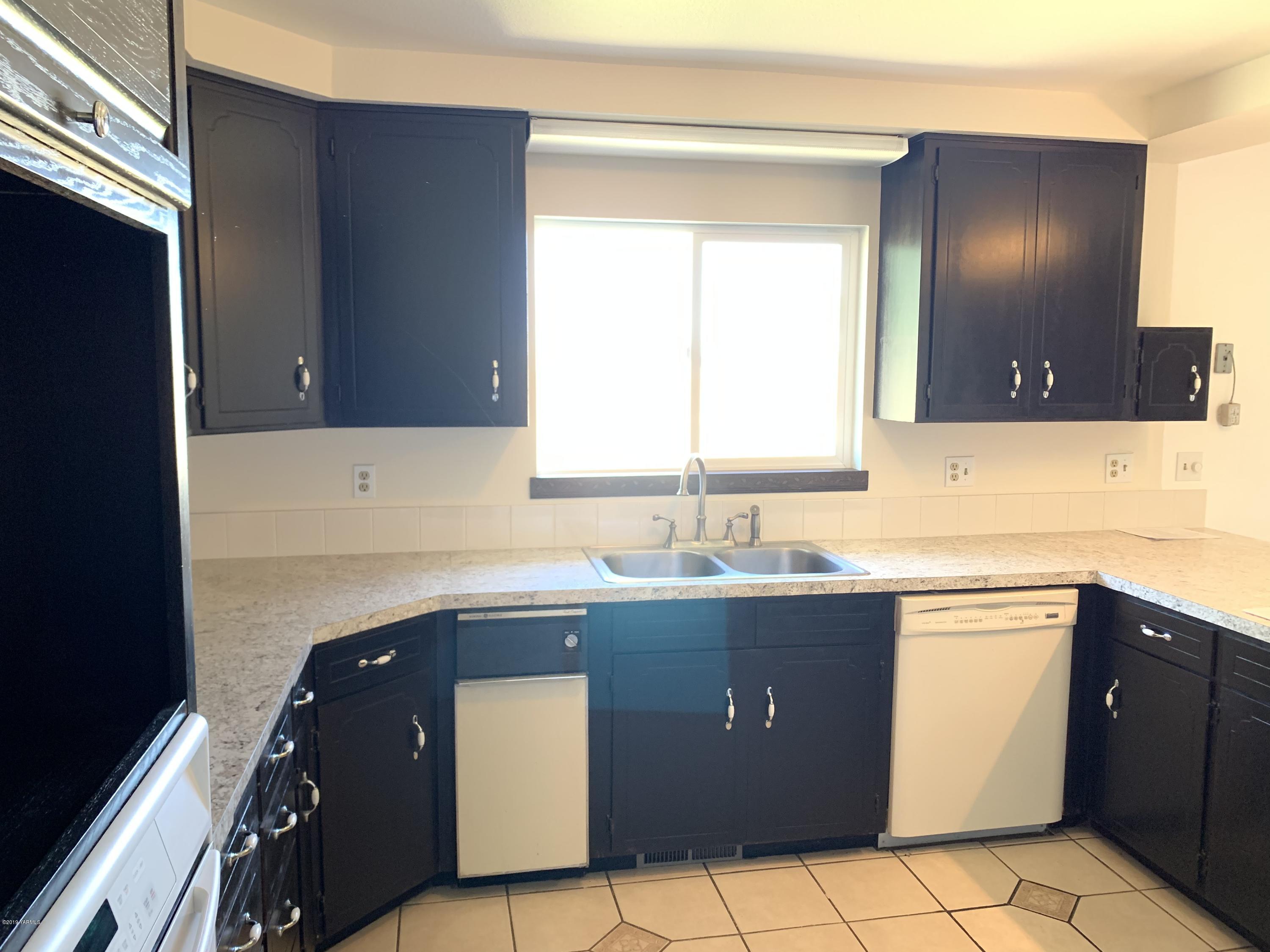 3341 Stone Road Yakima, WA 98908 - Photo 9 of 42 a kitchen with a sink a stove and cabinets