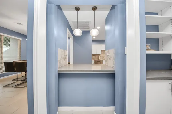 a view of cabinets with a sink and wooden floor