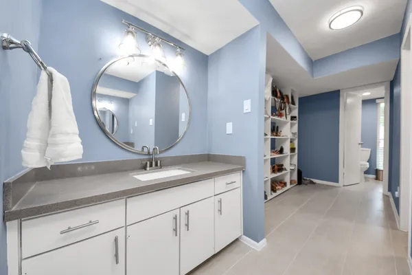 a bathroom with a double vanity sink and a mirror