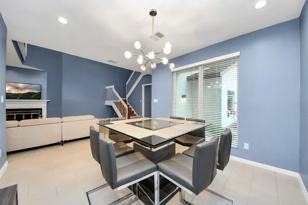 a dining room with a table and chairs