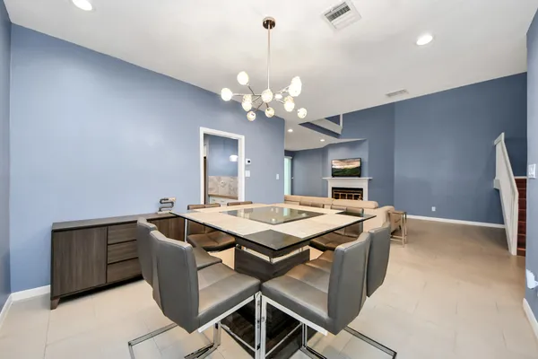 a view of a dining room with a table and chairs