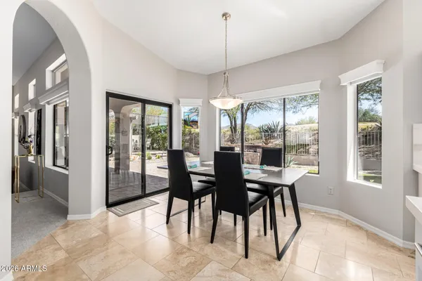 a large white kitchen with a large window