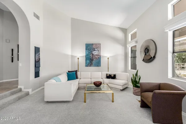 a dining room with furniture a chandelier and window