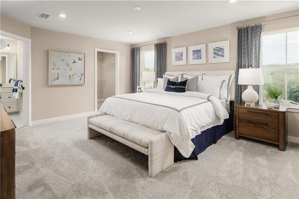 a spacious bedroom with a bed and a couch