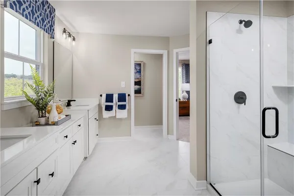 a bathroom with a double vanity sink a mirror a shower and a bathtub