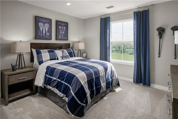 a bed sitting in a bedroom next to a window