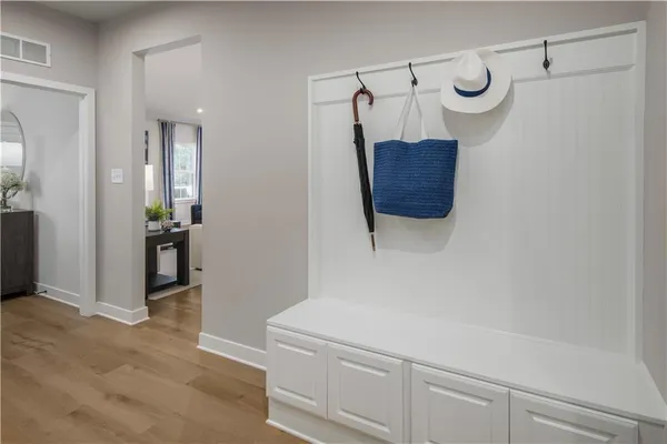 a room with a cabinet and a mirror