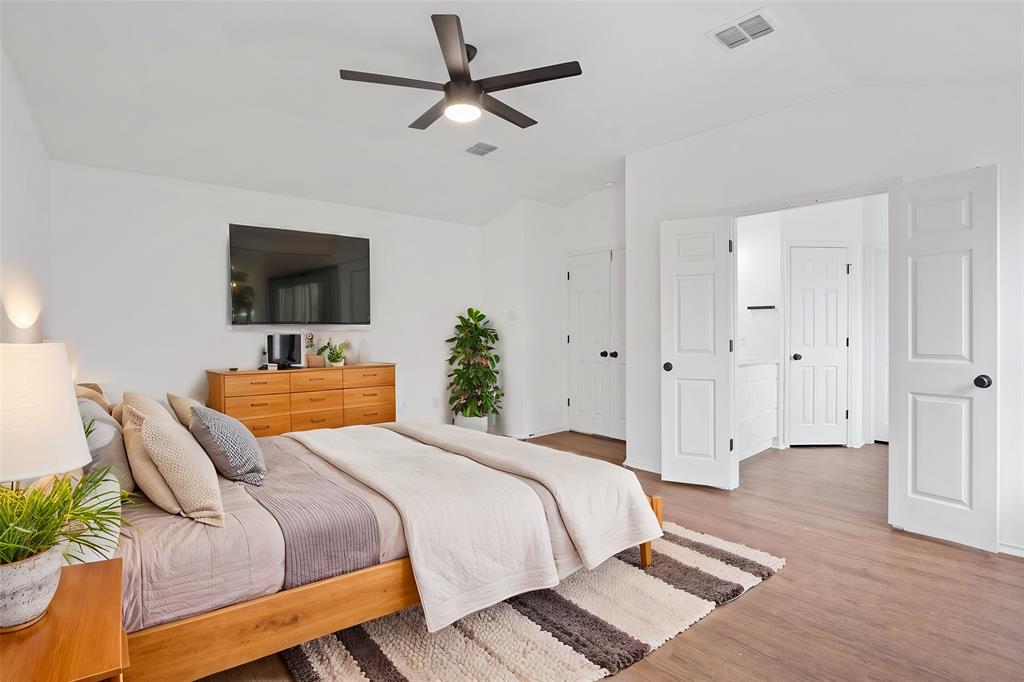 4429 East Hove Loop Austin, TX 78749 - Photo 11 of 27 a bedroom with a bed a flat screen tv and a couch