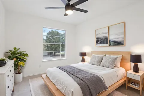 a bedroom with a bed and a potted plant