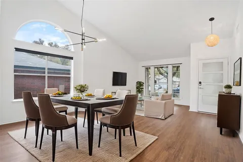 a view of a dining room with furniture and wooden floor