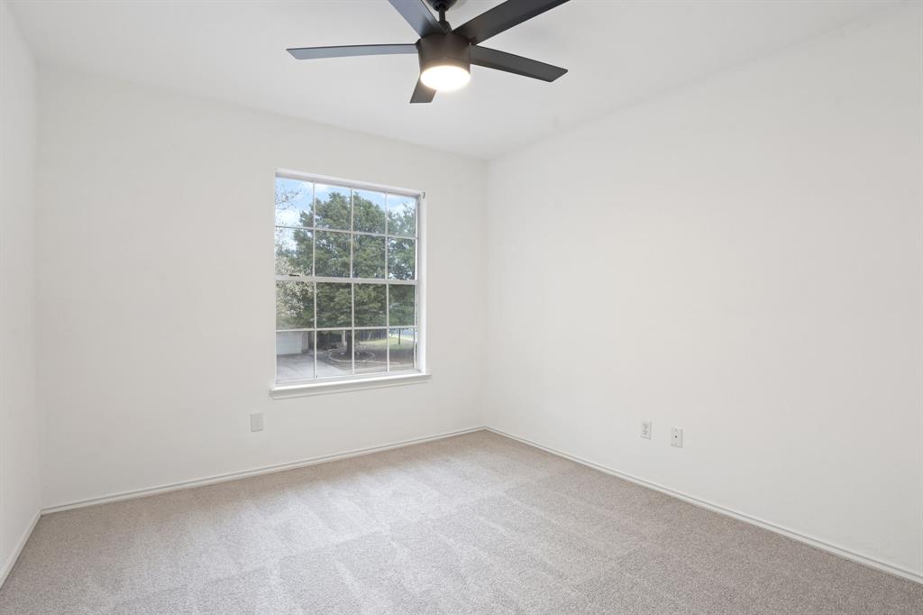 4429 East Hove Loop Austin, TX 78749 - Photo 21 of 27 an empty room with a window and a fan