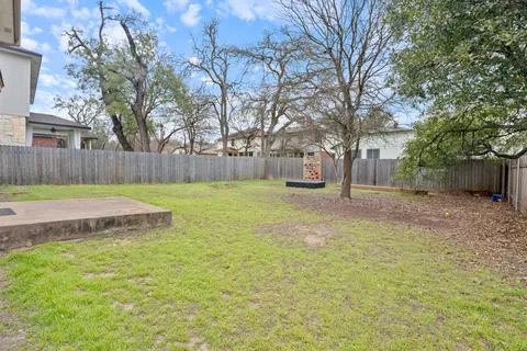 a view of a backyard with large trees