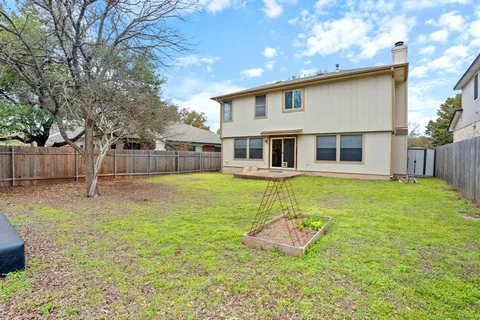 a view of a house with a yard patio and a slide
