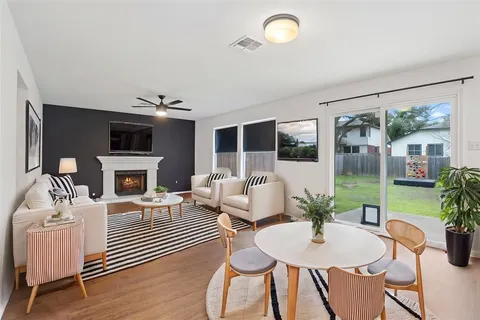 a living room with furniture a fireplace and a flat screen tv