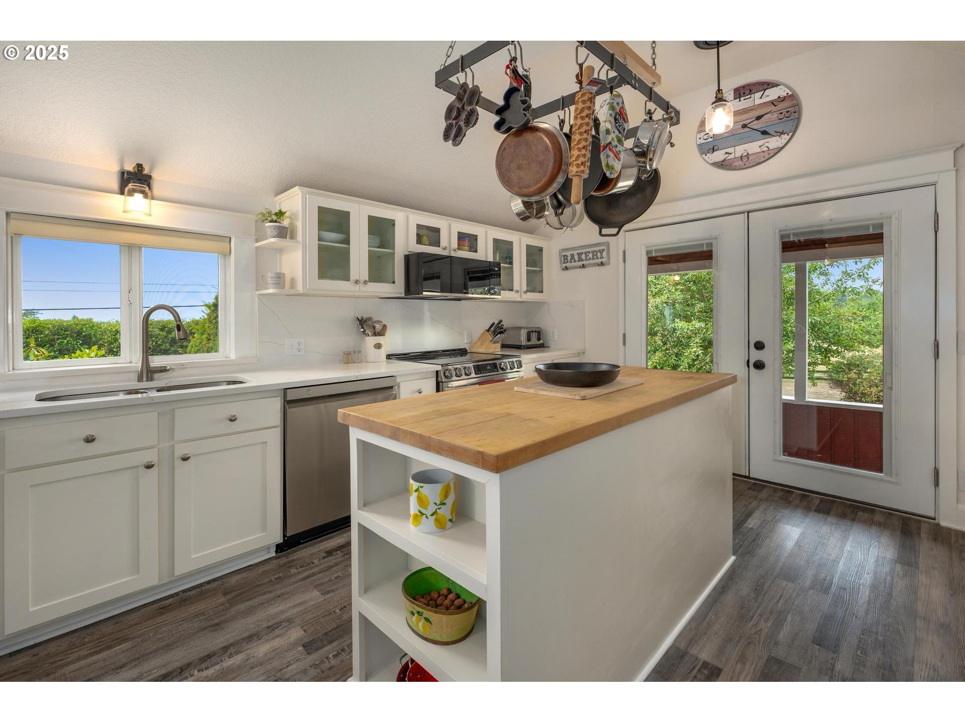 8918 Southwest Grabhorn Road Beaverton, OR 97007 - Photo 11 of 46 a kitchen with a sink a stove cabinets and wooden floor