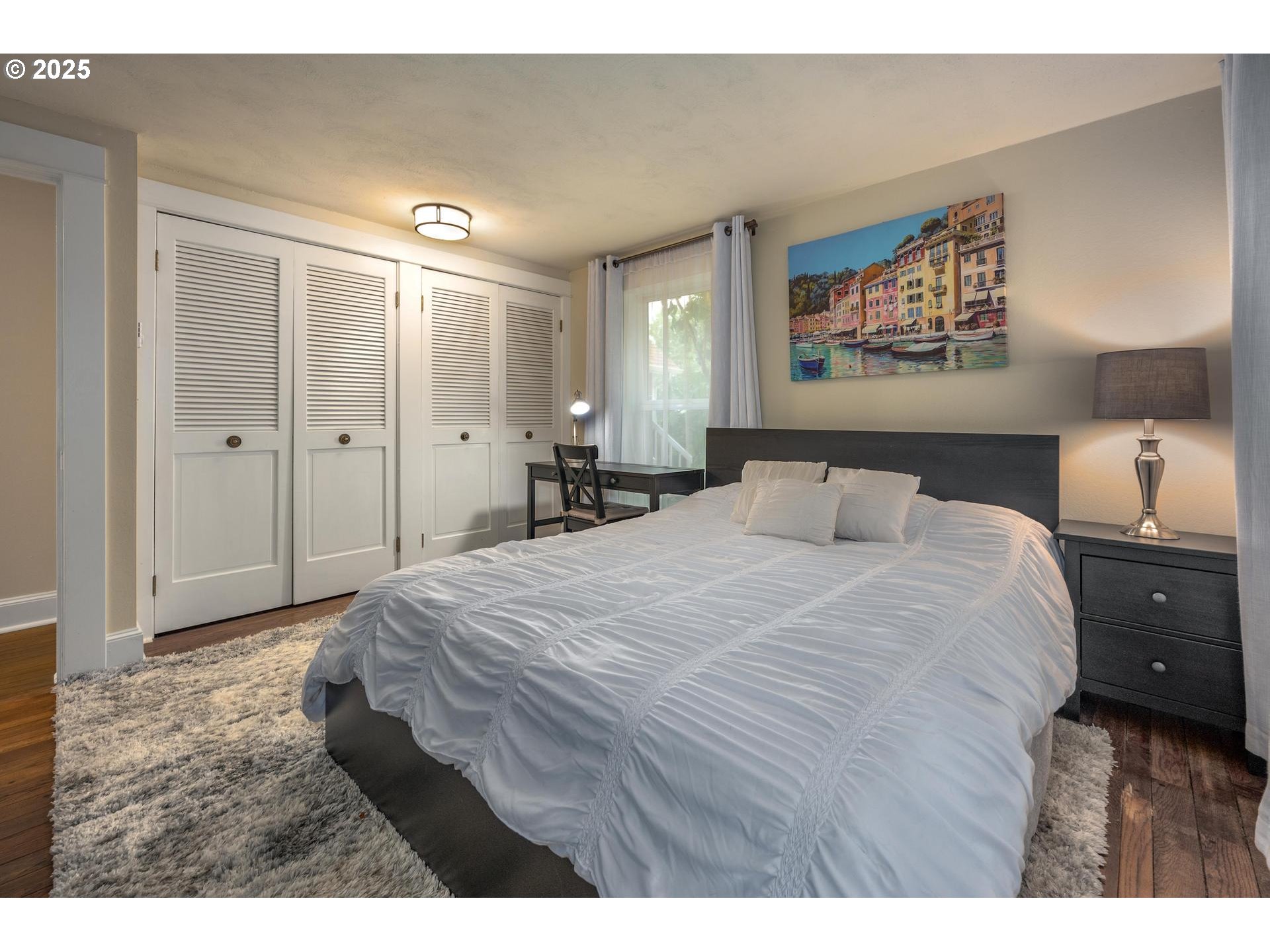 8918 Southwest Grabhorn Road Beaverton, OR 97007 - Photo 17 of 46 a bedroom with a bed and painting on the wall