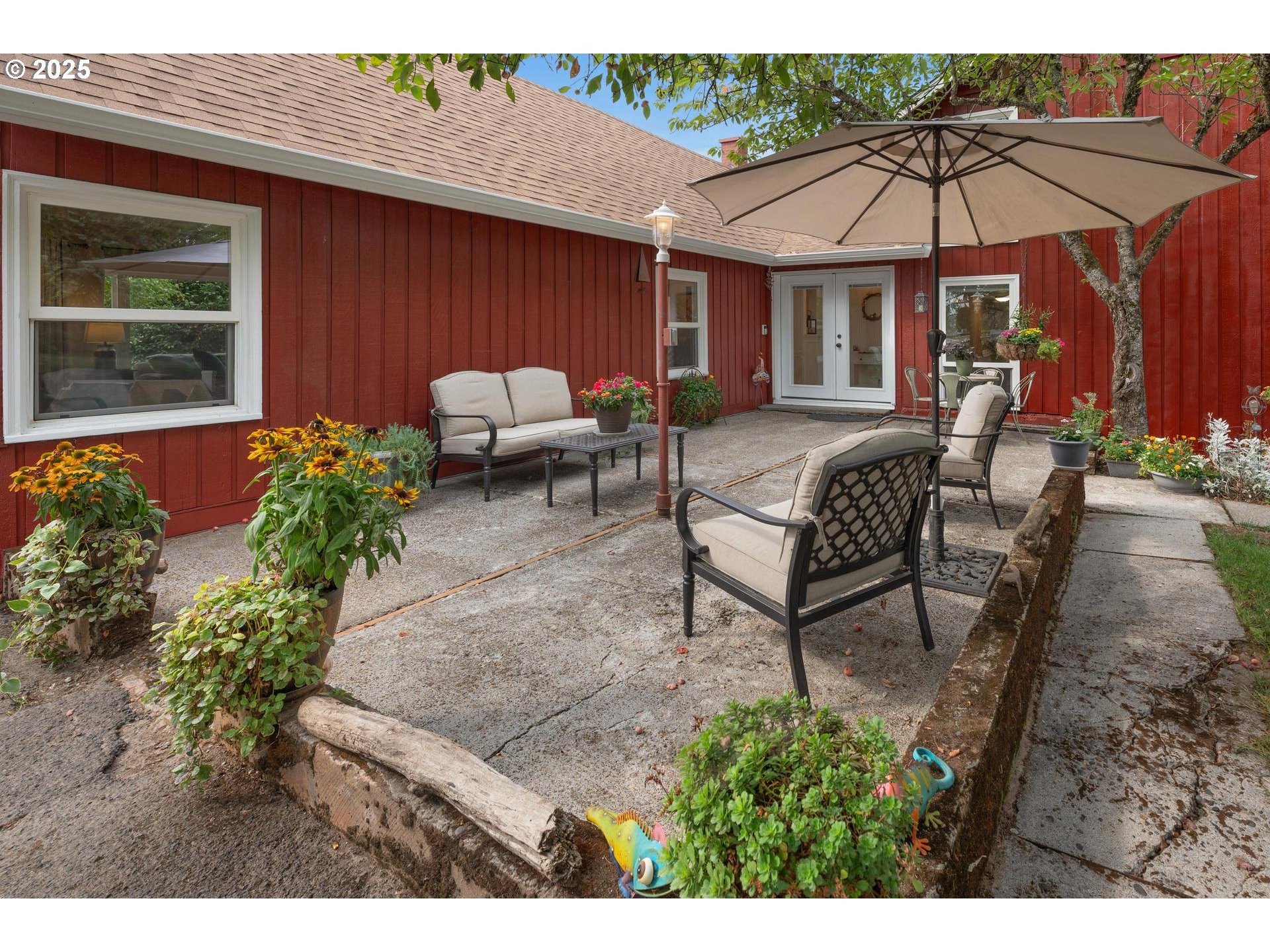 8918 Southwest Grabhorn Road Beaverton, OR 97007 - Photo 2 of 46 a backyard of a house with table and chairs