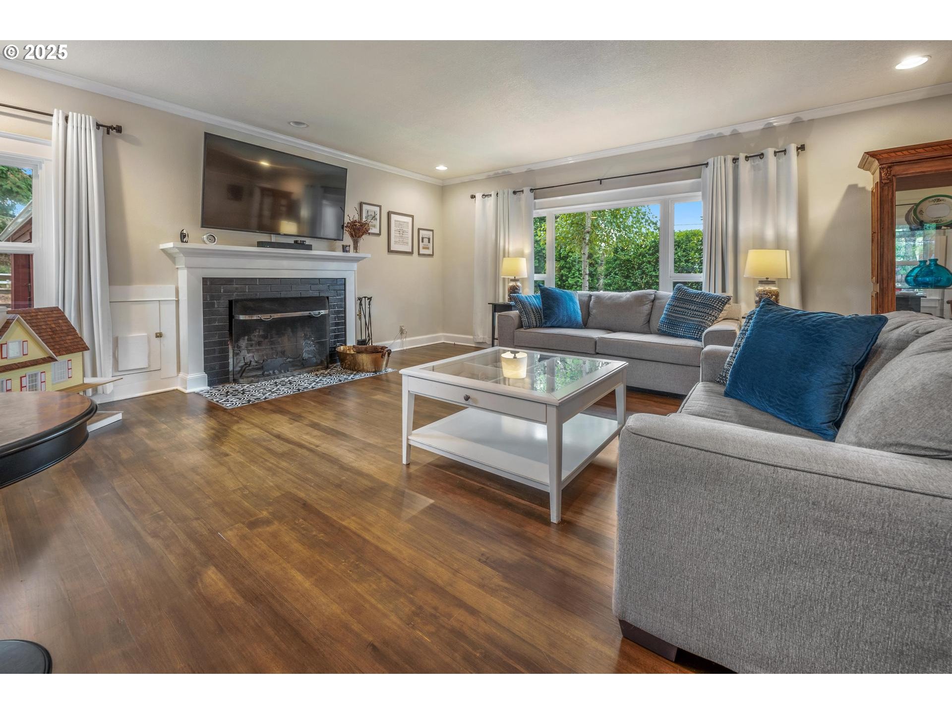 8918 Southwest Grabhorn Road Beaverton, OR 97007 - Photo 4 of 46 a living room with furniture a fireplace and a large window