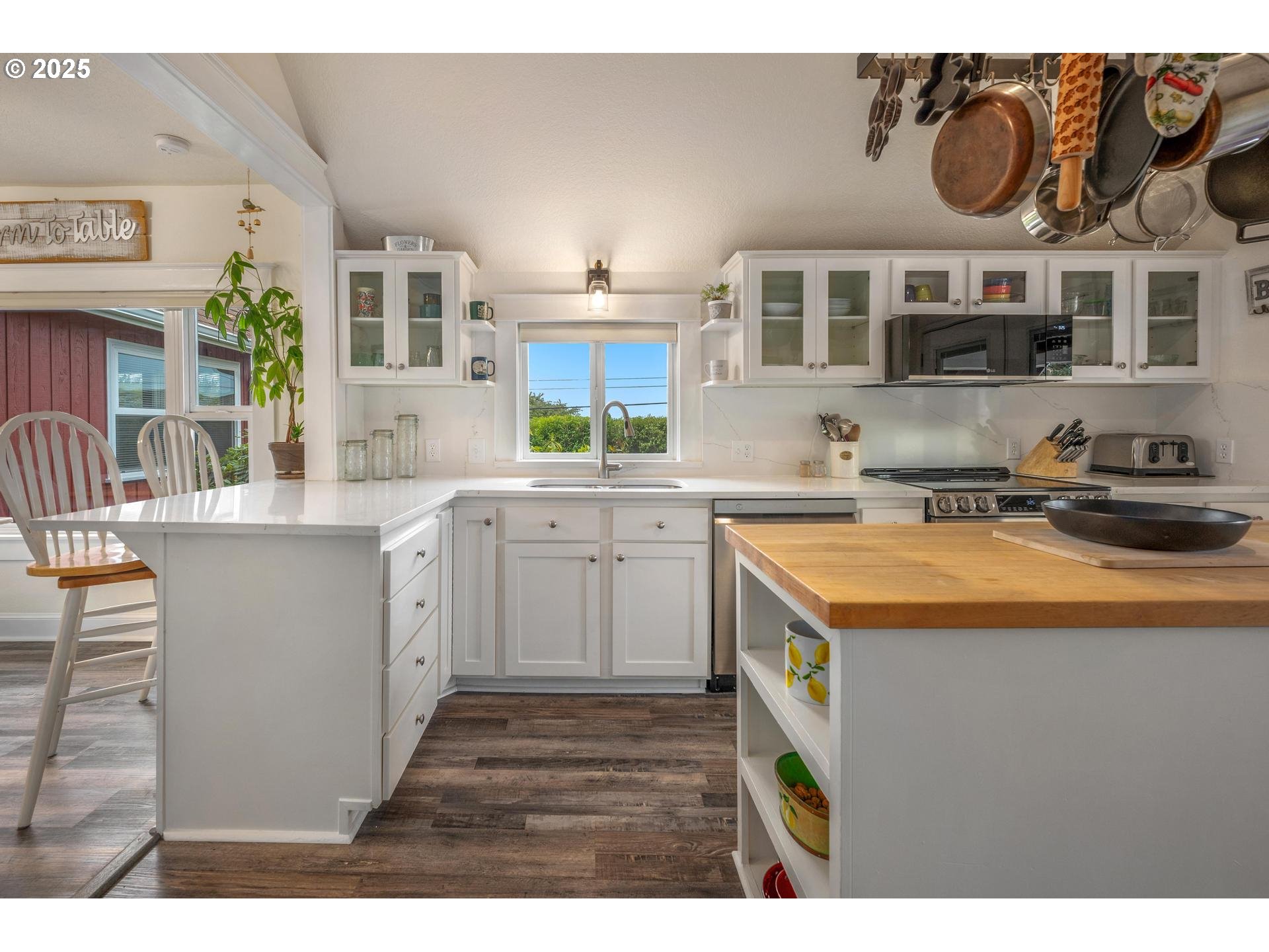 8918 Southwest Grabhorn Road Beaverton, OR 97007 - Photo 10 of 46 a kitchen with stainless steel appliances granite countertop a sink and cabinets