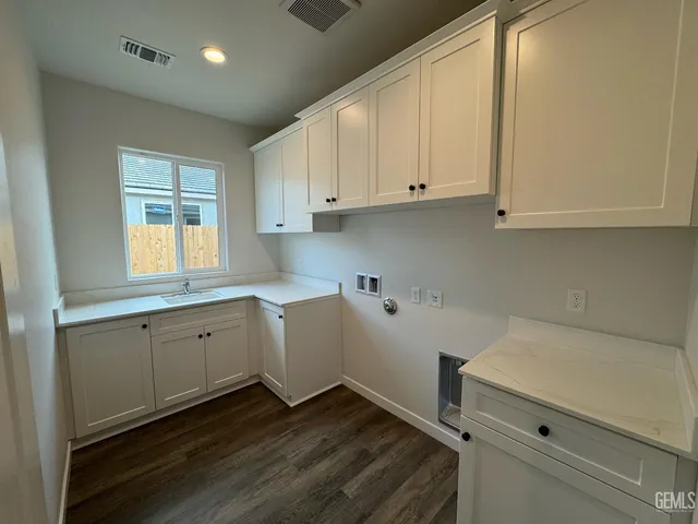 a kitchen with sink cabinets and window