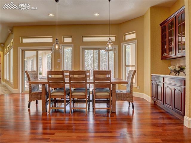 15925 Winding Trail Road Colorado Springs, CO 80908 - Photo 9 of 36 Casual Dining Area Adjacent to the Kitchen with Two Walkouts to the Expansive, 1200sf Trex Deck