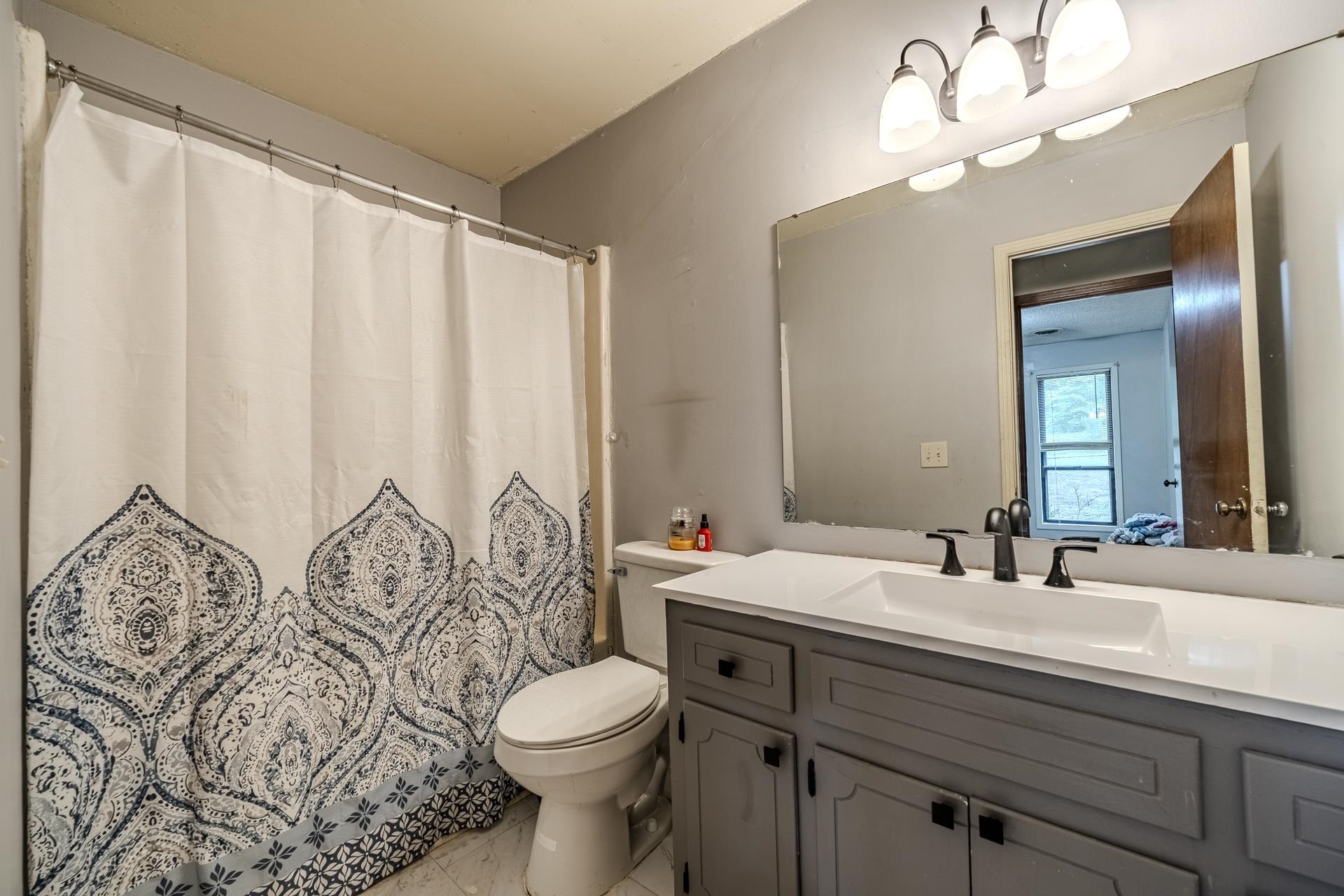 259 Oakview Drive Adamsville, TN 38310 - Photo 21 of 32 Bathroom vanity featuring a white countertop, an integrated rectangular sink, and matte black hardware