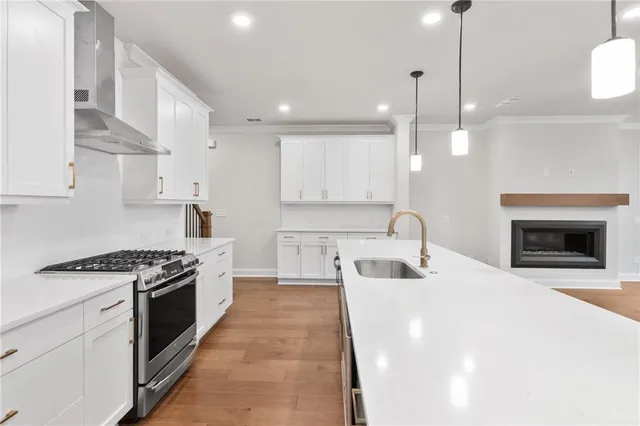 a kitchen with kitchen island a sink stainless steel appliances and cabinets