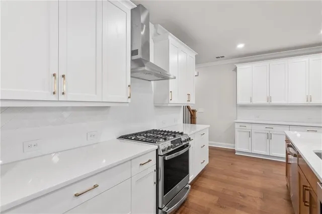a kitchen with granite countertop a sink a stove and cabinets